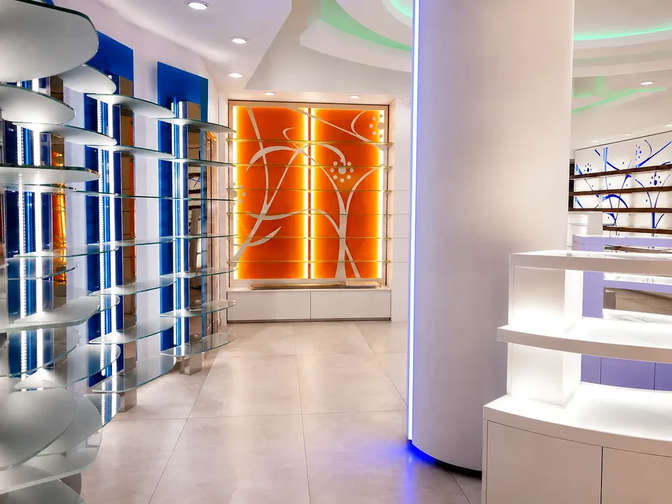 Curved white furniture between blue and orange walls