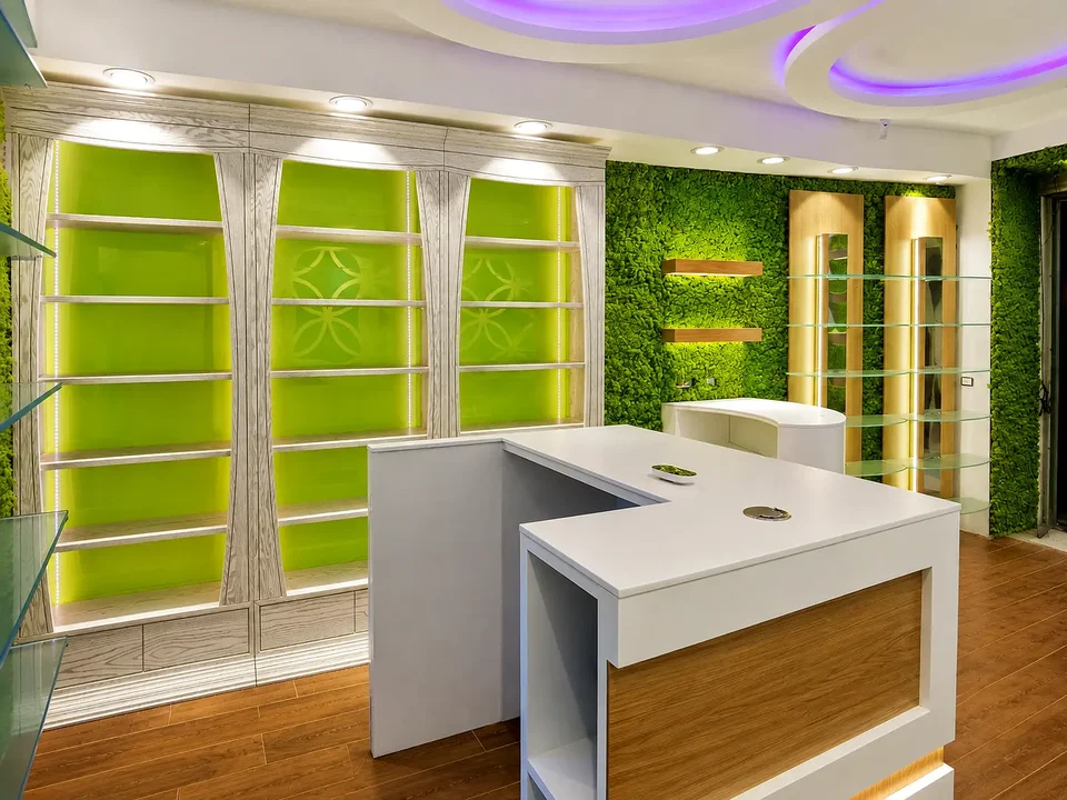 White and timber counter in front of green niches