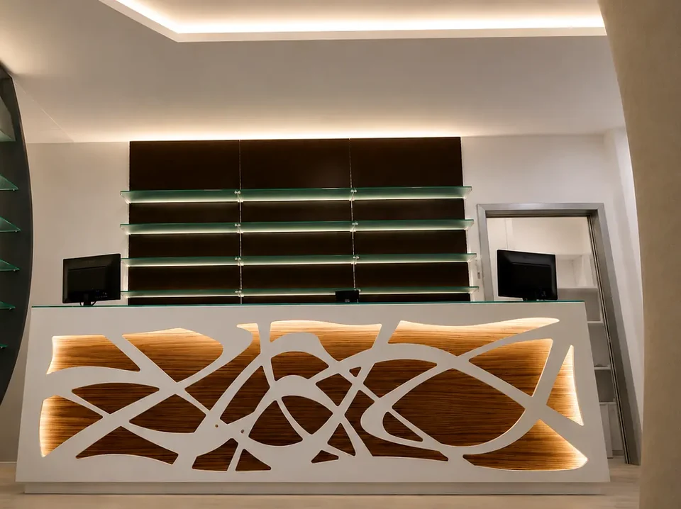 Counter with perforated front set against dark shelving