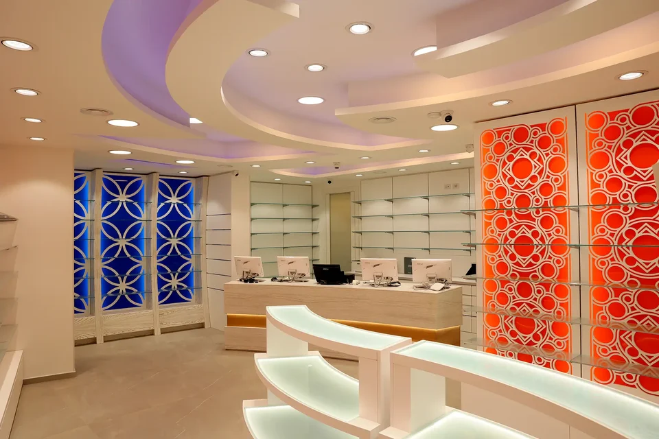 White counter and shelving between orange and blue panels