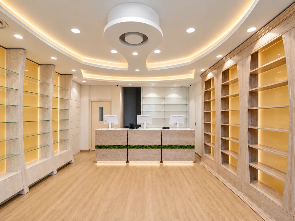 Bright pharmacy with yellow shelving and central counter