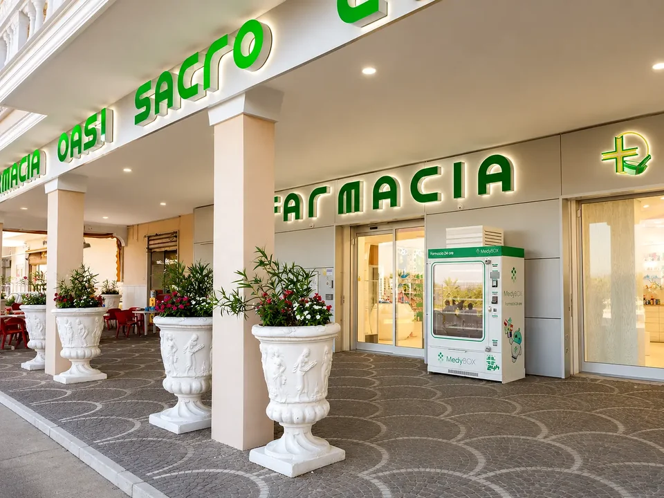 Entrance to OASI Sacro Cuore Pharmacy with green signage