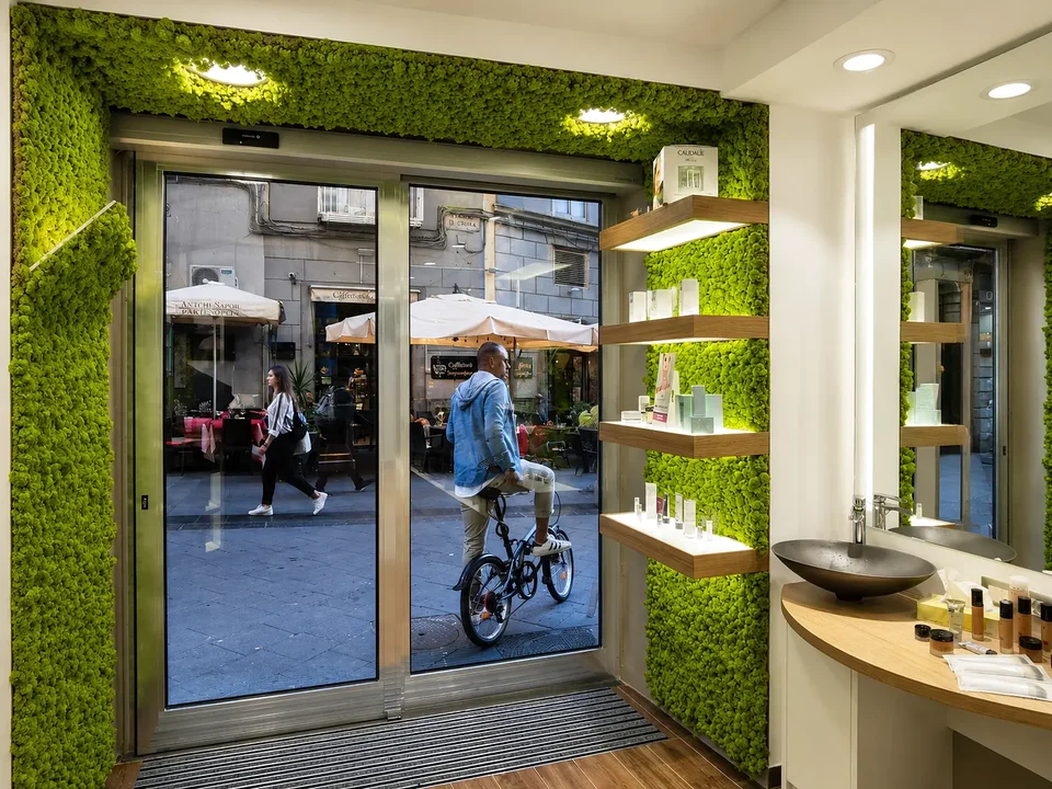 Entrance framed by a living wall and shelving