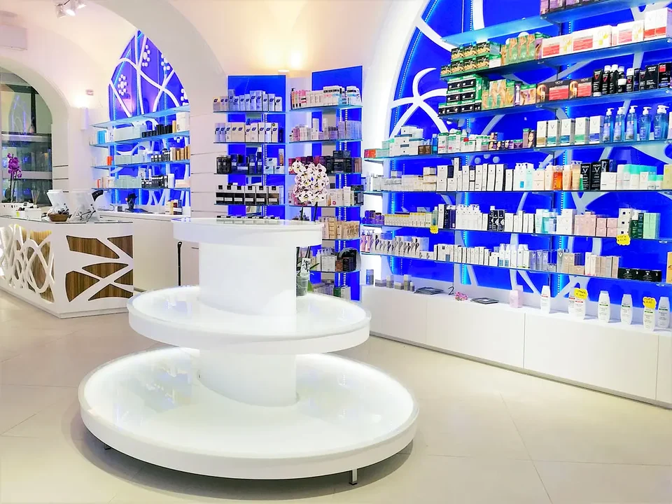 Circular display island in front of blue shelving