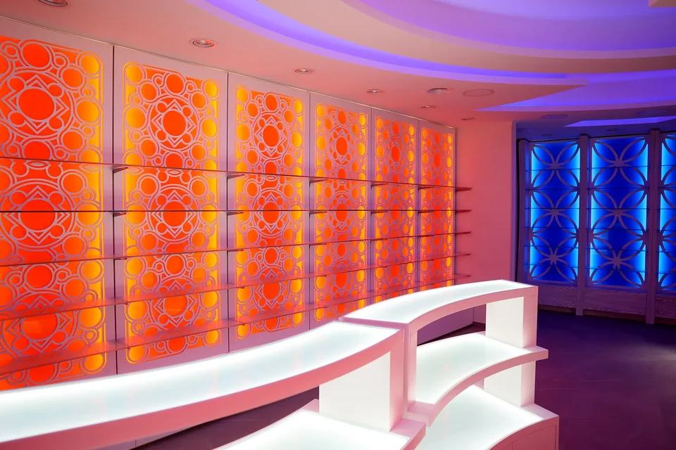 Orange backlit feature wall and curved counter