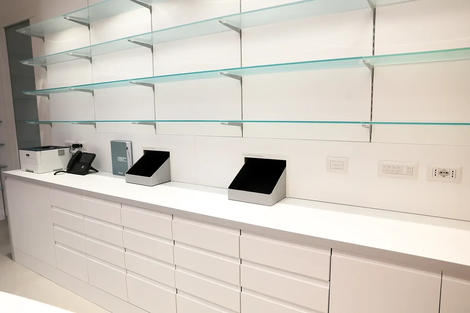 Technical workstations integrated into white furniture and glass