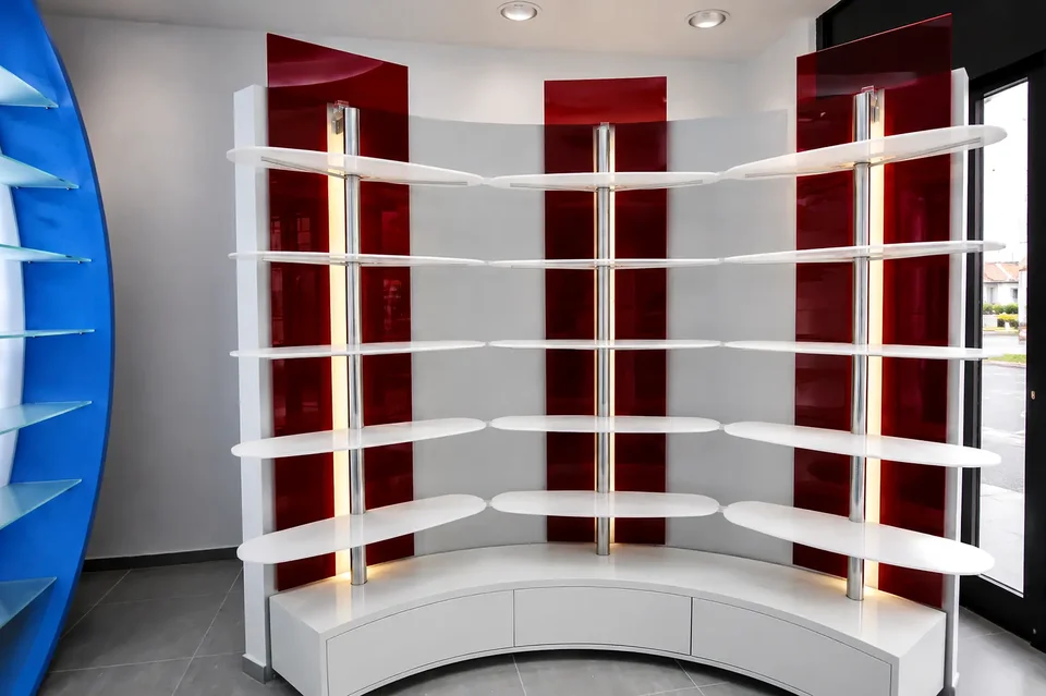 Curved white shelving with red backdrop