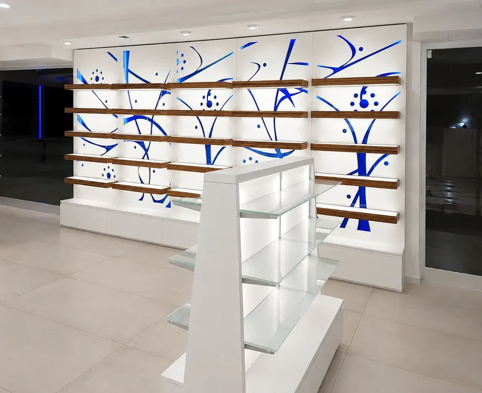 Glass shelving and central counter in a bright pharmacy