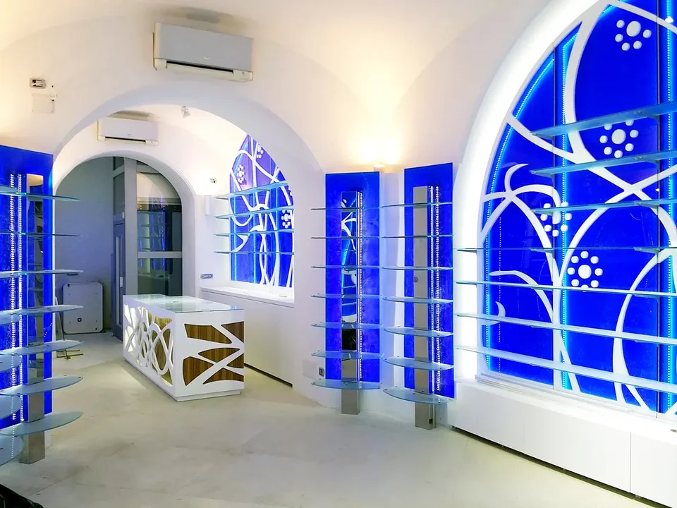 Seating and blue display cases in an arched pharmacy interior